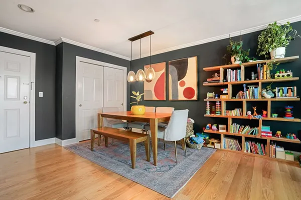 a living room with furniture a rug and a book shelf