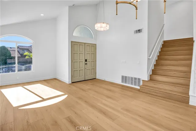 a view of an empty room with stairs and ventilation