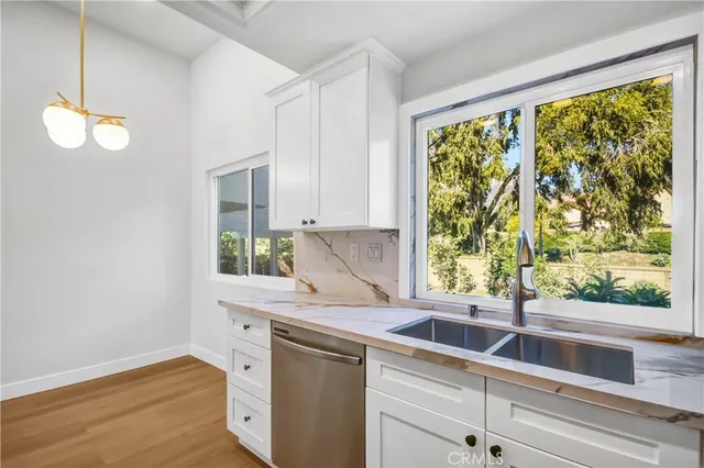 a kitchen with a sink and large window