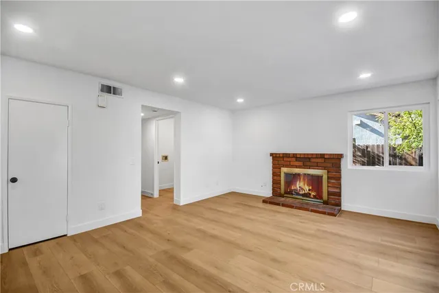 a view of empty room with window and fireplace