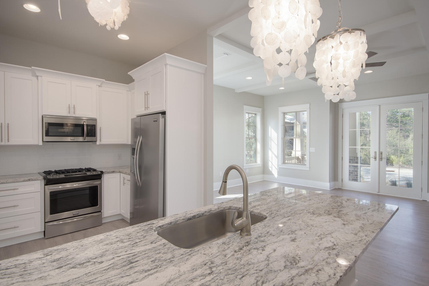 196 Matt's Way Santa Rosa Beach, FL 32459 - Photo 8 of 26 a kitchen with stainless steel appliances granite countertop a stove oven and a refrigerator with white cabinets