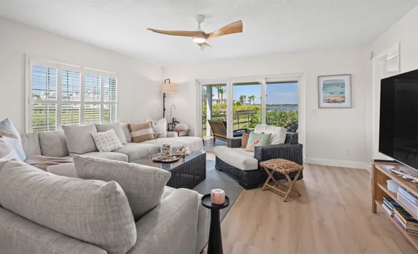a living room with furniture a large window and a flat screen tv