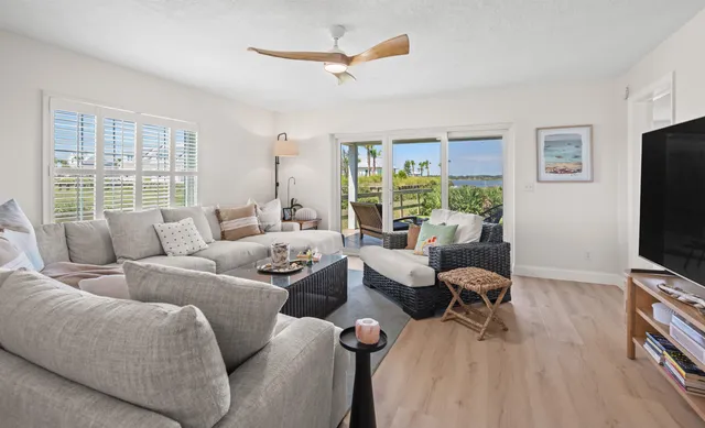a living room with furniture a large window and a flat screen tv