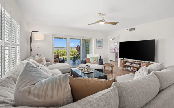 a living room with furniture and a wooden floor