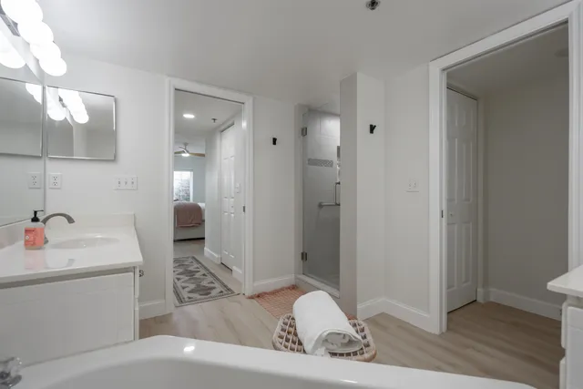 a bathroom with a sink a toilet and shower