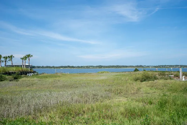 a view of a chair and table in balcony with wooden floor