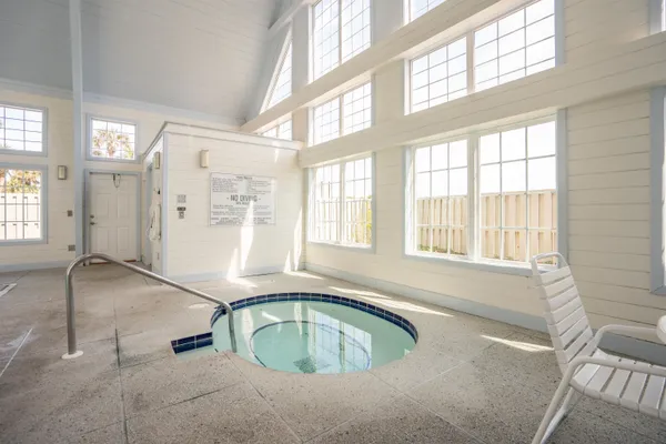 a view of a patio with dining table and chairs with wooden floor