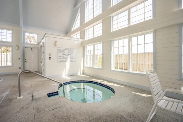 a view of a patio with dining table and chairs with wooden floor