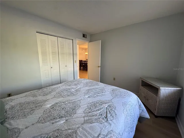 a bedroom with a bed and a chair