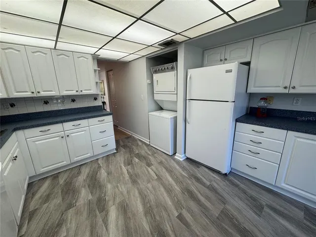 a kitchen with white cabinets and white appliances