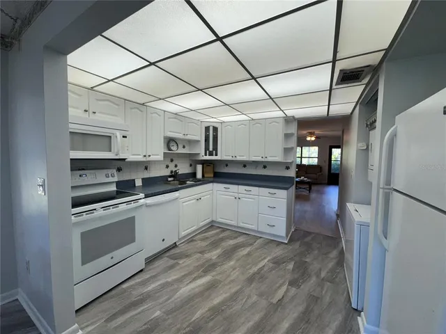 a kitchen with stainless steel appliances granite countertop a refrigerator and a stove
