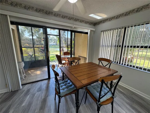 a dining room with furniture a chandelier and wooden floor