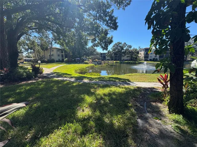 a view of a swimming pool with an outdoor seating and lake view