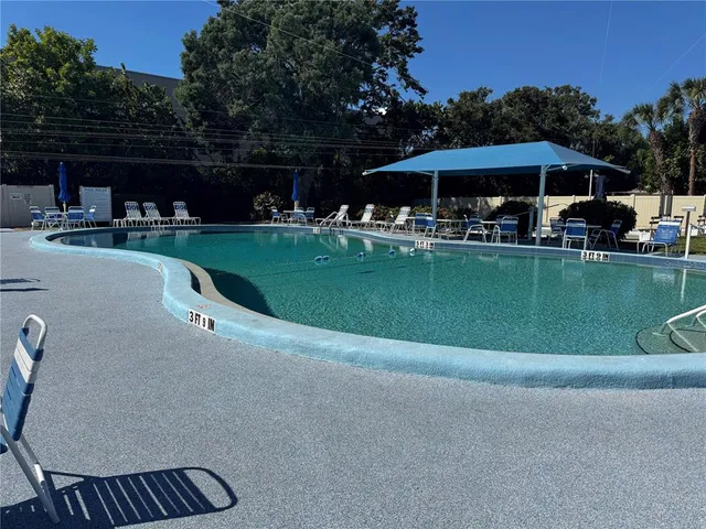 a view of swimming pool and outdoor seating