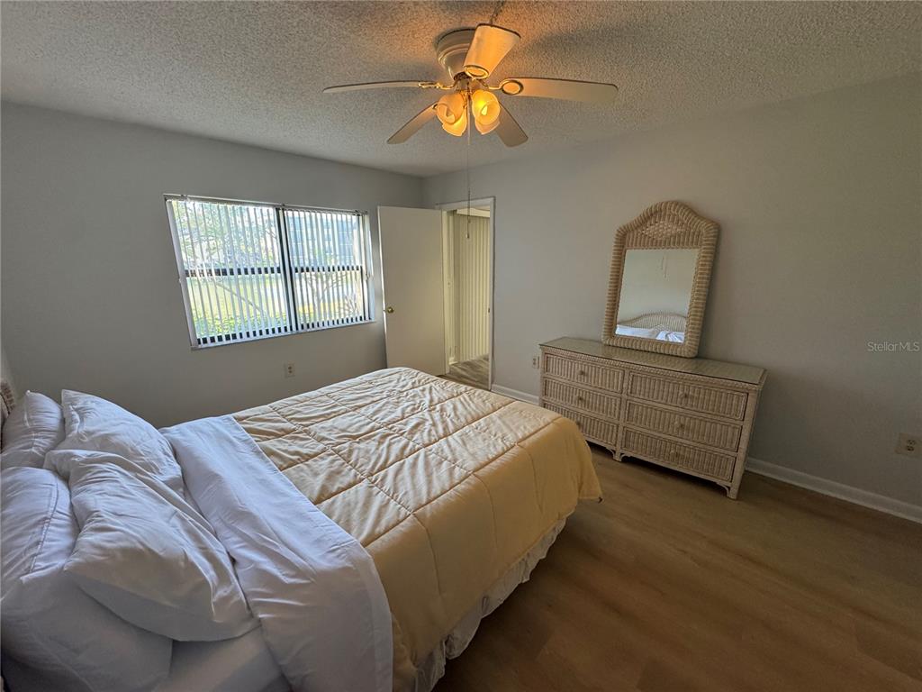 315 30th Avenue West, Unit 101B Bradenton, FL 34205 - Photo 5 of 20 a bedroom with a bed and a chandelier