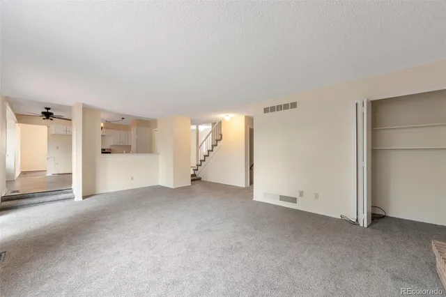 an empty room with a empty space and windows