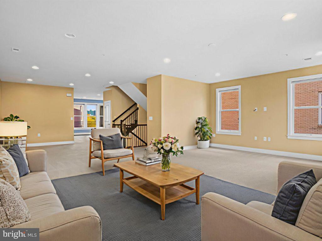 1901 Main Line Boulevard, Unit 102 Alexandria, VA 22301 - Photo 16 of 34 a living room with furniture and a potted plant