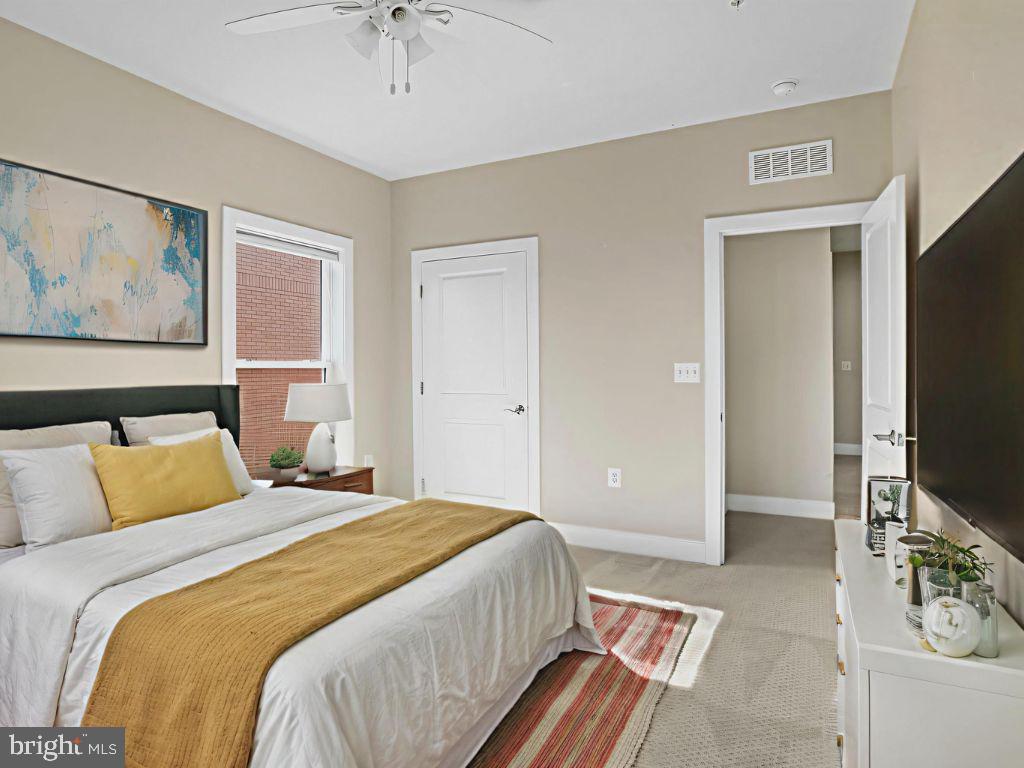 1901 Main Line Boulevard, Unit 102 Alexandria, VA 22301 - Photo 27 of 34 a bedroom with a bed and a flat screen tv