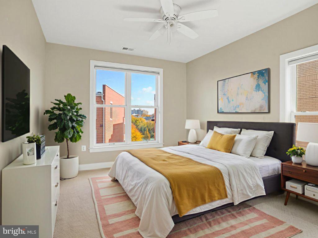 1901 Main Line Boulevard, Unit 102 Alexandria, VA 22301 - Photo 28 of 34 a bedroom with a large bed and a flat screen tv