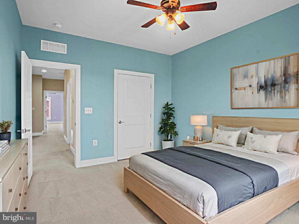 1901 Main Line Boulevard, Unit 102 Alexandria, VA 22301 - Photo 30 of 34 a bedroom with a large bed and a chandelier