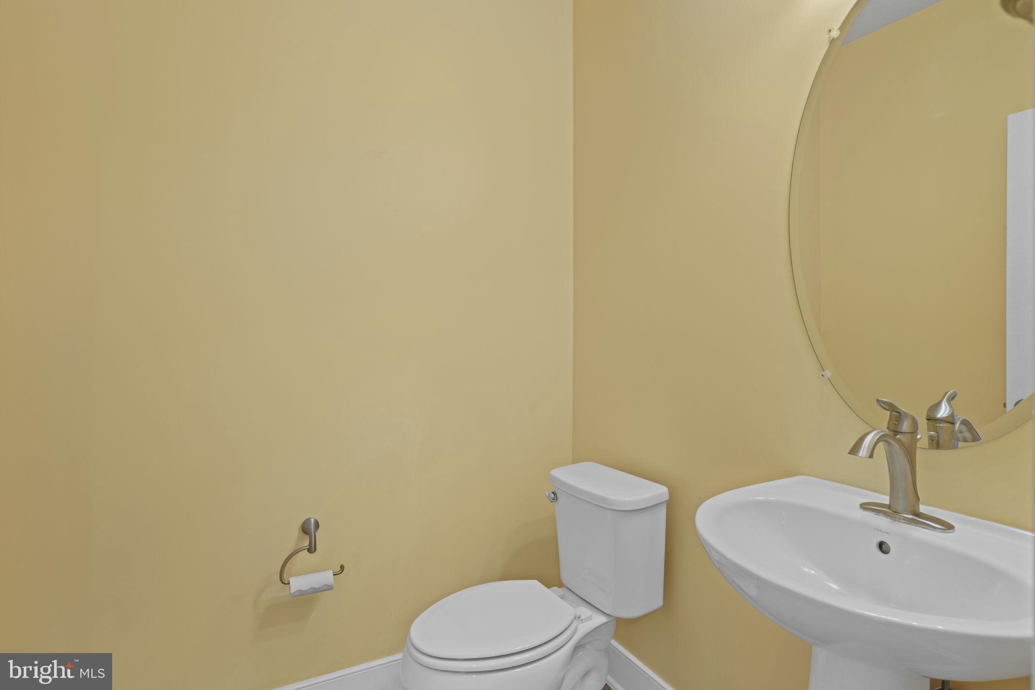 1901 Main Line Boulevard, Unit 102 Alexandria, VA 22301 - Photo 31 of 34 a white toilet sitting next to a white sink and vanity