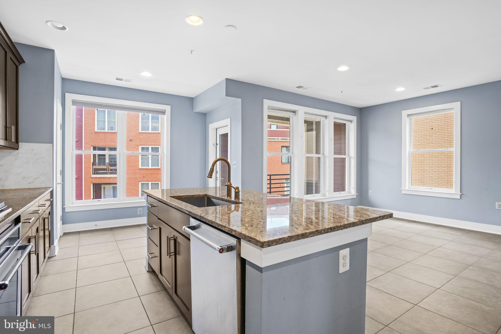 1901 Main Line Boulevard, Unit 102 Alexandria, VA 22301 - Photo 8 of 34 a kitchen with stainless steel appliances granite countertop a stove a sink and a refrigerator