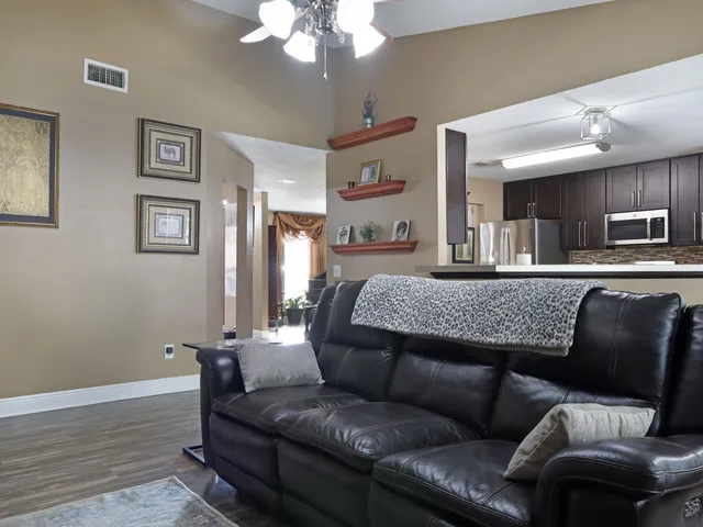 a view of a workspace with furniture and wooden floor