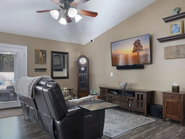 a view of a workspace with furniture and wooden floor