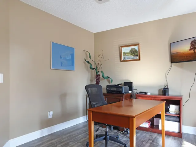 a living room with furniture a table and wooden floor