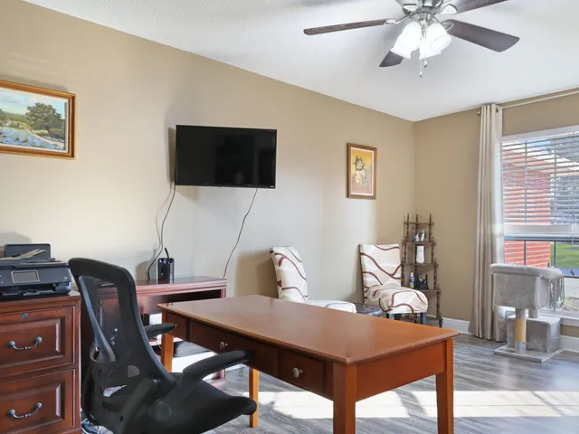 a kitchen with stainless steel appliances granite countertop a refrigerator a sink dishwasher a stove and white countertops with wooden floor