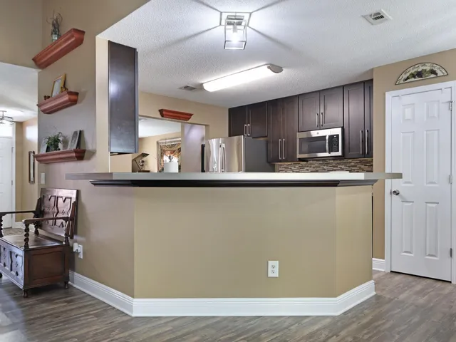 a view of a dining room with furniture large windows and wooden floor
