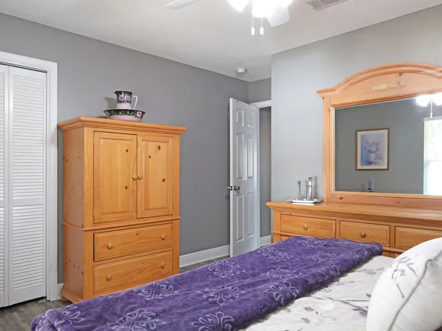 a bedroom with a bed and a dresser