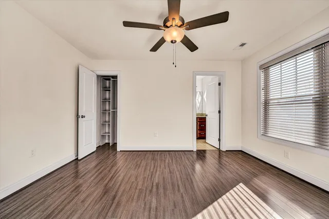 a bathroom with a granite countertop sink a toilet and shower