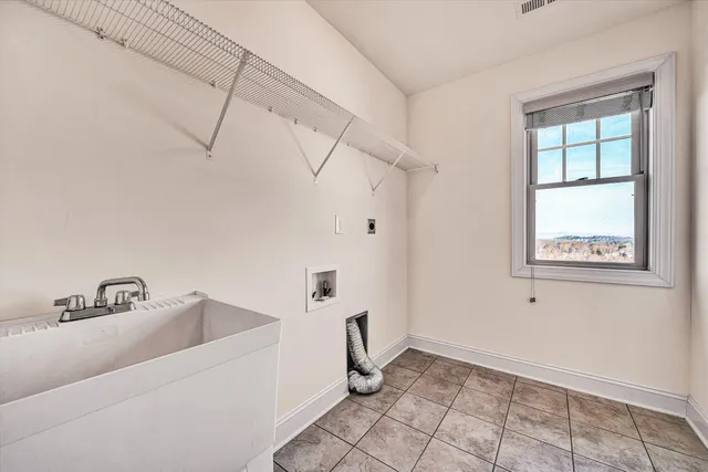 a bathroom with a granite countertop sink a mirror and a bathtub