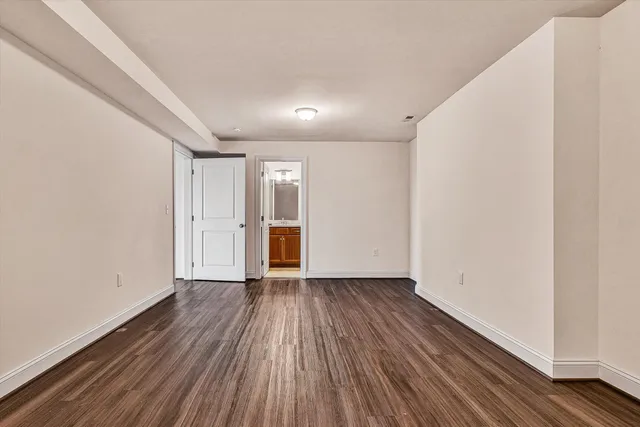 a view of a room with wooden floor