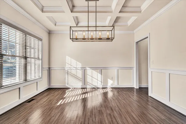 a view of a room with wooden floor and white walls