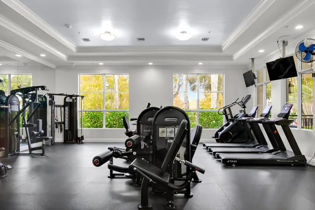 a view of a patio with a table and chairs and potted plants