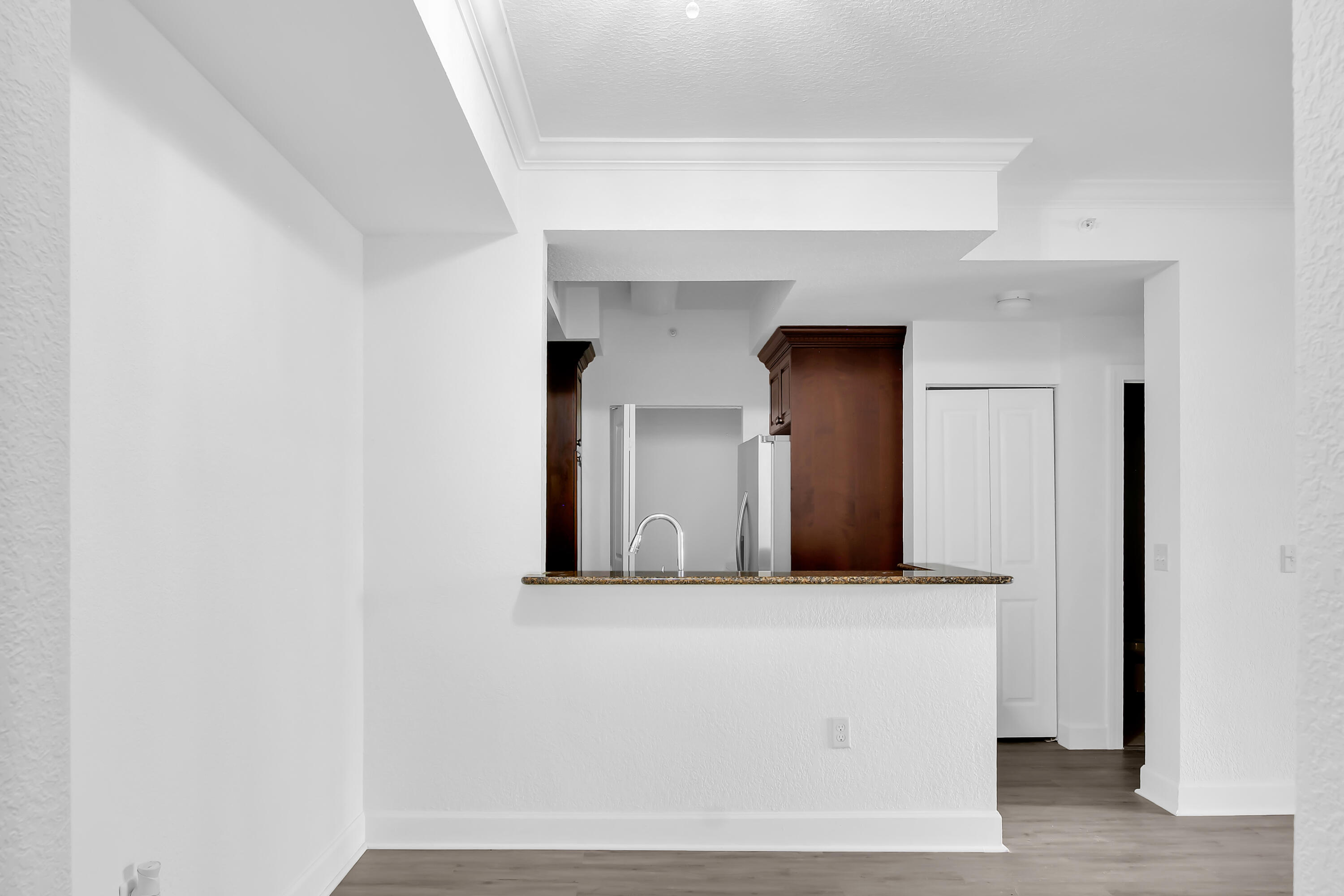 1660 Renaissance Commons Boulevard, Unit 2122 Boynton Beach, FL 33426 - Photo 22 of 38 a view of a hallway with wooden floor and a cabinet