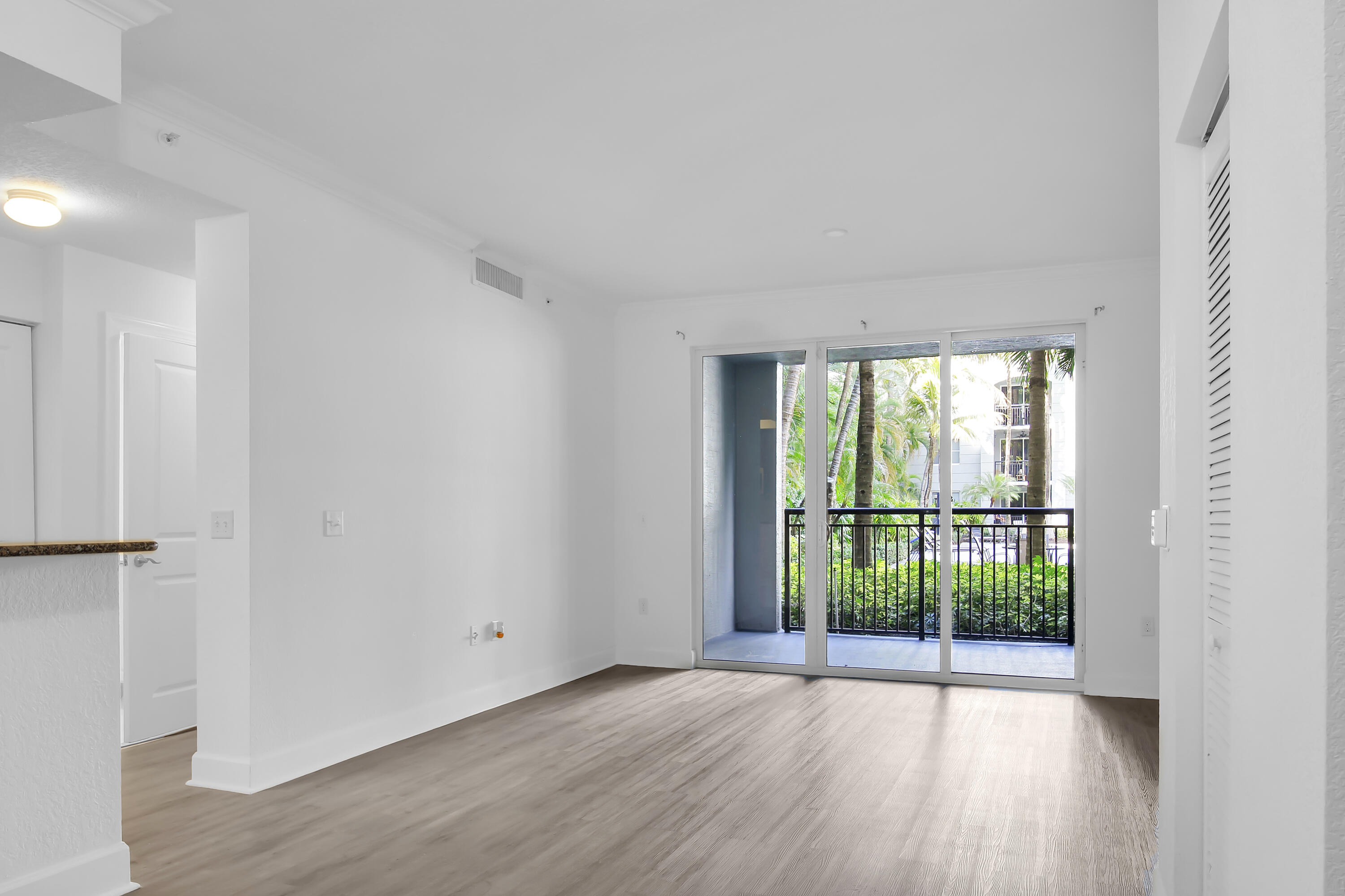 1660 Renaissance Commons Boulevard, Unit 2122 Boynton Beach, FL 33426 - Photo 24 of 38 a view of a room with wooden floor and doors