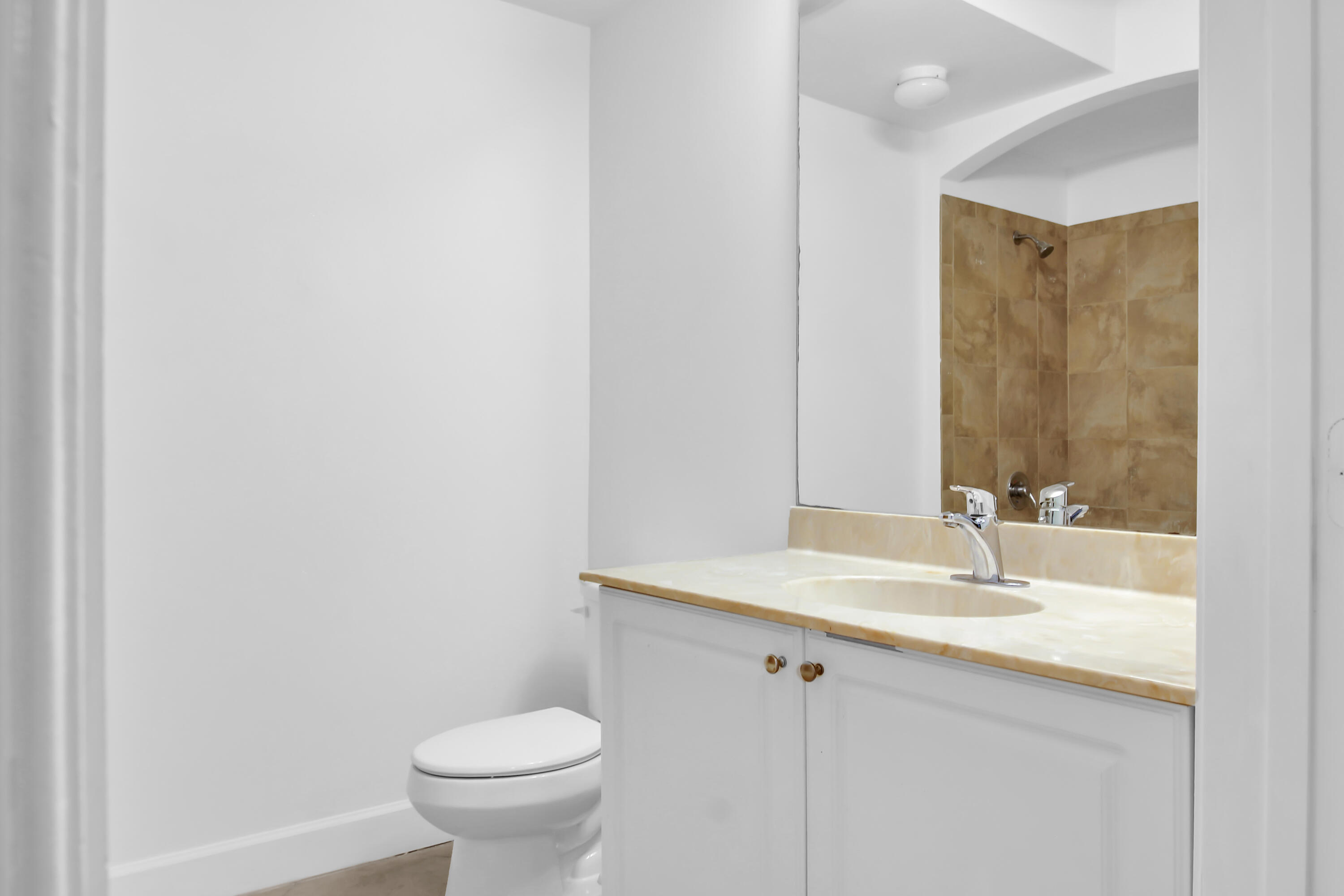 1660 Renaissance Commons Boulevard, Unit 2122 Boynton Beach, FL 33426 - Photo 28 of 38 a bathroom with a sink toilet and a mirror