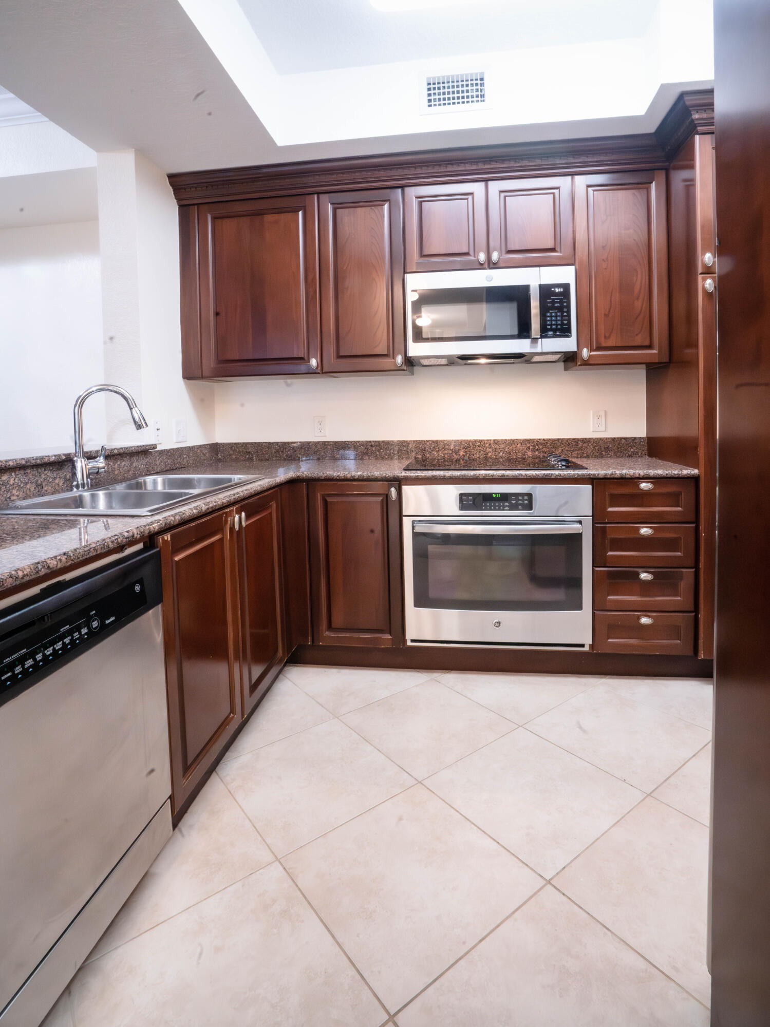 1660 Renaissance Commons Boulevard, Unit 2122 Boynton Beach, FL 33426 - Photo 3 of 38 a kitchen with stainless steel appliances granite countertop a stove microwave and sink