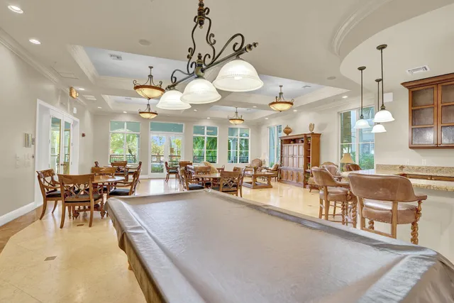 a living room with furniture a chandelier and a dining table