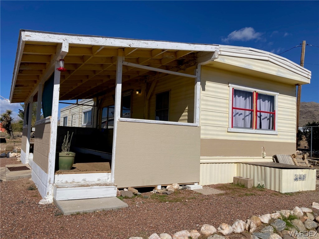 3460 Bouse Road Golden Valley, AZ 86413 - Photo 8 of 79 a view of a house with a door and wooden fence