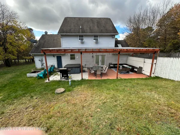 a view of a house with backyard sitting area and garden