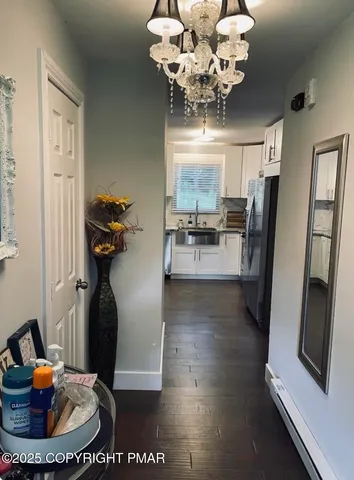 a living room with furniture and a chandelier