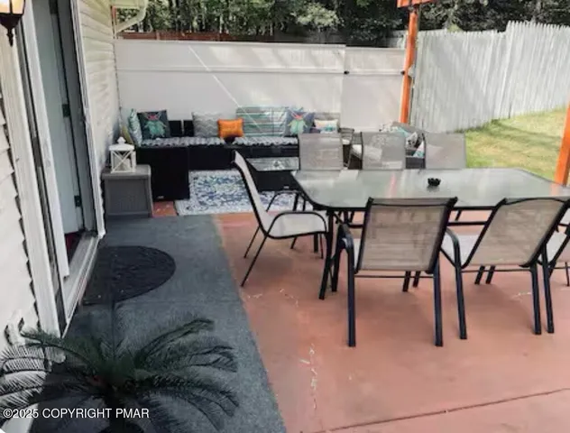 a dining room with furniture and a potted plant
