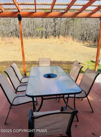 a view of a dining room with furniture and window