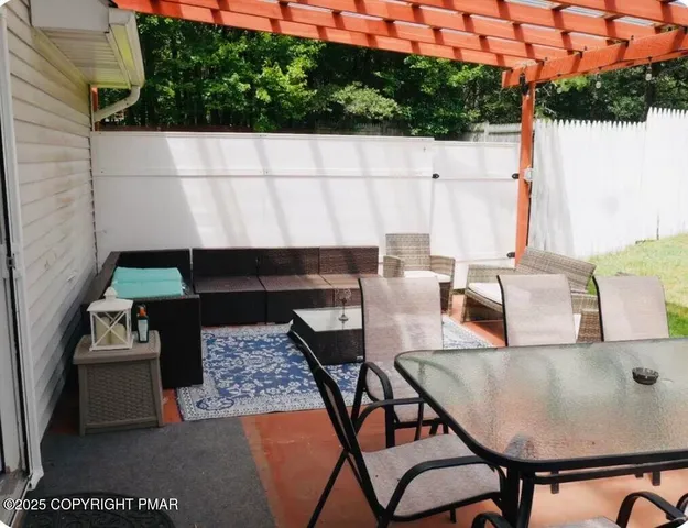 a barbeque area with table and chairs