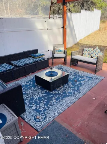 a living room with furniture and a rug