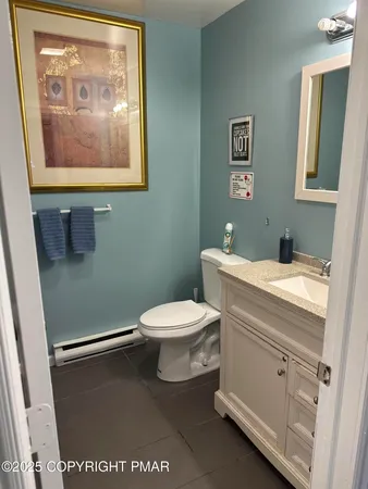 a bathroom with a toilet a sink and a mirror